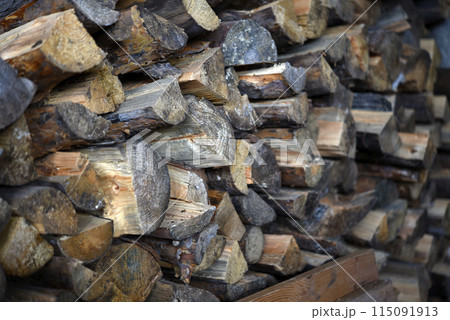 There's firewood in the closet. Stacked firewood. Storage of firewood. 115091913