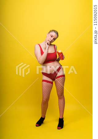 Young beautiful slender female eating french fries. Concept of un healthy fat junk and healthy food Young beautiful slender female eating french fries. Concept of un healthy fat junk and healthy food 115092015