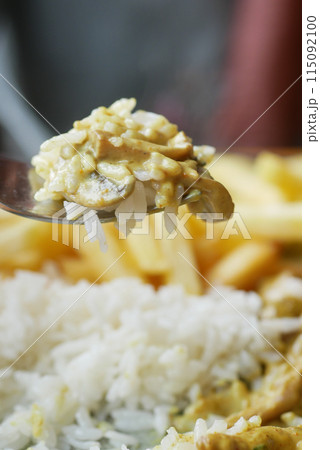 Closeup of fork pick rice mixed with chicken  115092100