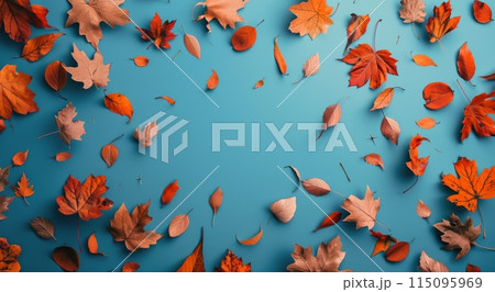 Red and Blue Autumn Leaves on a Teal Background 115095969