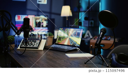 Jib down shot of wooden desk in studio with podcast gear technology recording sound for social media channel production. Live broadcasting space with specialized tech in dimly lit apartment 115097496