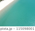 Aerial view of a blue sea surface water texture background and sun reflections Aerial flying drone view water surface texture on sunny tropical ocean 115098001