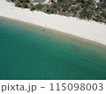 Aerial view of a blue sea surface water texture background and sun reflections Aerial flying drone view water surface texture on sunny tropical ocean 115098003