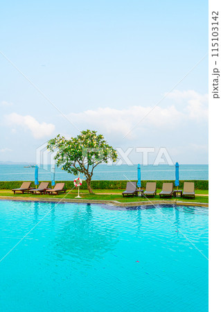 chair pool and umbrella around swimming pool 115103142