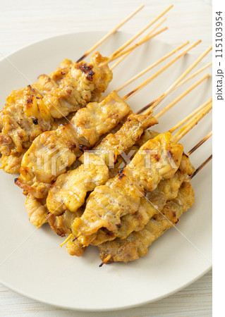 Pork satay with peanut sauce pickles which are cucumber slices and onions in vinegar 115103954