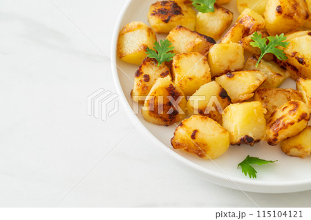 Roasted or grilled potatoes on plate Roasted or grilled potatoes on plate 115104121