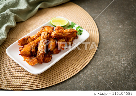 Fried Snapper Belly on white plate 115104585