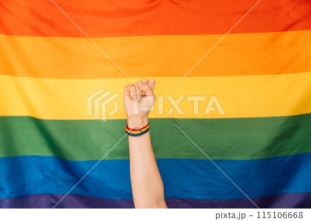 Fist with pride strap in front of LGBT flag Fist with pride strap in front of LGBT flag 115106668