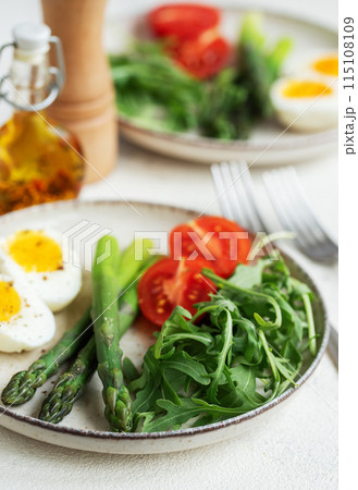 Fresh Spring Salad With Boiled Eggs, Asparagus, and Tomatoes on a Bright Day Fresh Spring Salad With Boiled Eggs, Asparagus, and Tomatoes on a Bright Day 115108109