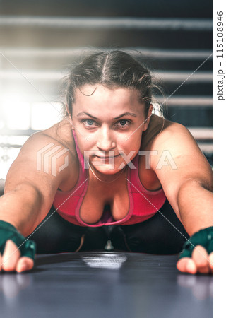 Young woman warming up in the gym. Flexibility girl doing exercising. Sports, healthy lifestyle Young woman warming up in the gym. Flexibility girl doing exercising. Sports, healthy lifestyle 115108946