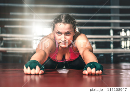 Young woman warming up in the gym. Flexibility girl doing exercising. Sports, healthy lifestyle 115108947