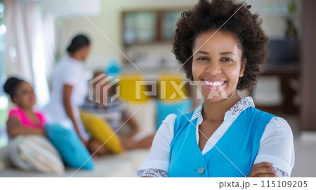 Smiling Housekeeper Standing in Modern Living Room, Professional Home Cleaning Service 115109205