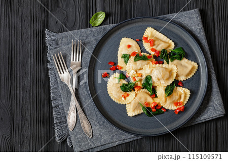 italian pasta mezzelune on a plate, top view 115109571