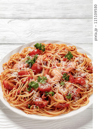 shrimp fra diavolo with spaghetti on a plate 115109580