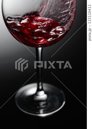 Closeup of red wine pouring. 115110411