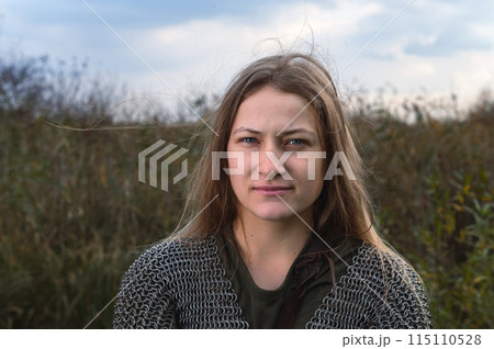 Woman soldier of the medieval army. Portrait of woman in image of medieval warrior. Beautiful woman in medieval chain mail. Woman soldier of the medieval army. Portrait of woman in image of medieval warrior. Beautiful woman in medieval chain mail. 115110528