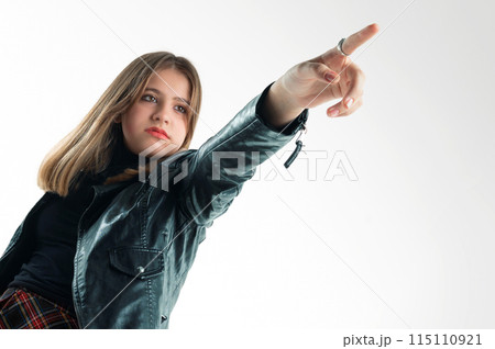 Portrait of a girl pointing her finger. Teenage girl pointing 115110921
