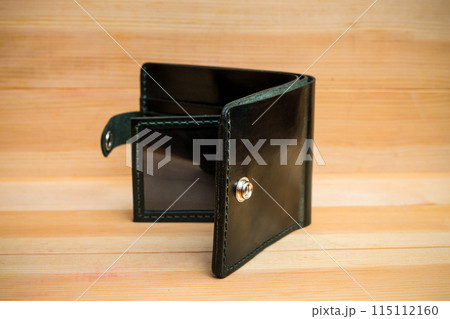 Men's wallet made of black leather on light wood, Shooting for the catalog 115112160