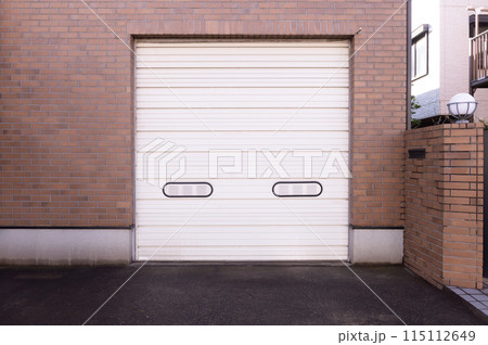 A closeup shot of automatic metal roller door used in factory, storage, garage, and industrial warehouse. The corrugated and foldable metal sheet offer space saving and provide urban and rustic feel 115112649