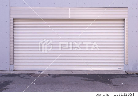 A closeup shot of automatic metal roller door used in factory, storage, garage, and industrial warehouse. The corrugated and foldable metal sheet offer space saving and provide urban and rustic feel 115112651