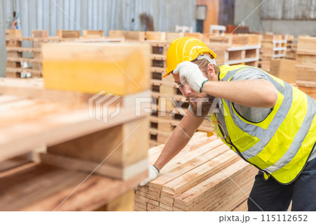 Man wearing safety uniform and yellow hard hat working checking quality wooden Man wearing safety uniform and yellow hard hat working checking quality wooden 115112652