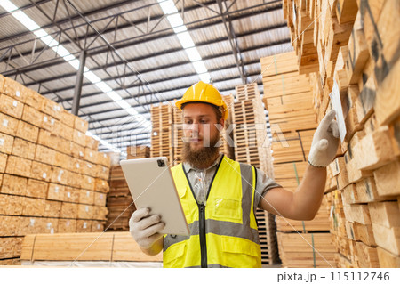 Worker Man with a bearded wearing safety uniform yellow hard hat using tablet Worker Man with a bearded wearing safety uniform yellow hard hat using tablet 115112746