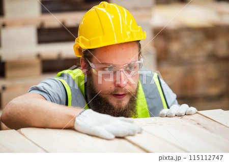 Man engineer carpenter wearing safety uniform and hard hat working checking quality Man engineer carpenter wearing safety uniform and hard hat working checking quality 115112747