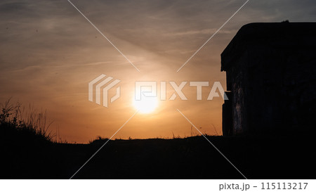 A sun is setting in the sky and the sky is dark A sun is setting in the sky and the sky is dark 115113217