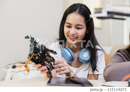 Happy two girl teen smile with braces students education stem hand robot model study 115114871