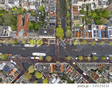 Kings Day 2024 in Amsterdam. Koningsdag, Koeningsdag in Capital of the Netherlands, Aerial Drone Fly Over Orange Suits. 115115212