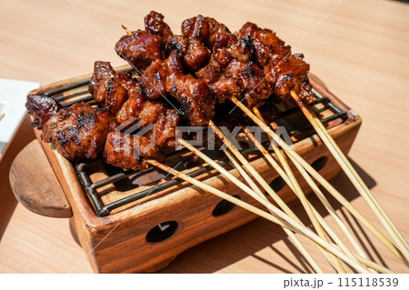 Homemade lamb or mutton satay marinated with spice and sweet soy sauce, coriander goat satay, served with chilli, soy sauce and tomato. Indonesian traditional satay 115118539