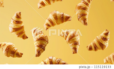 Levitating lush fresh croissants fly in the air on a yellow background. High quality photo 115119133