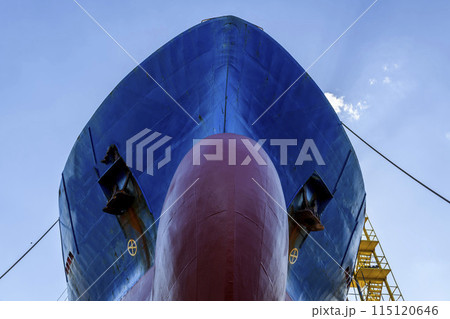 Cargo vessel in dry dock on ship repairing yard. Bulbous bow. Cargo vessel in dry dock on ship repairing yard. Bulbous bow. 115120646