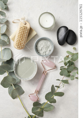 Organic cosmetic green clay,  brush, massage stone  and eucalyptus branch  115120761