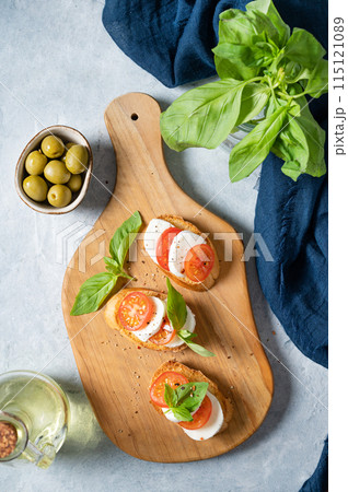 Caprese sandwiches with tomatoes, mozzarella cheese and fresh basil and toast Caprese sandwiches with tomatoes, mozzarella cheese and fresh basil and toast 115121089
