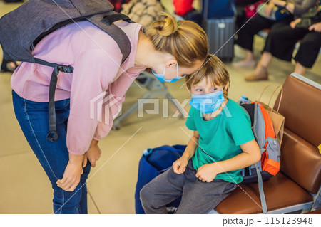Mother and son travelers with medical face mask to protection the coronavirus in airport Mother and son travelers with medical face mask to protection the coronavirus in airport 115123948