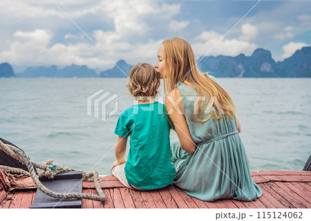 Mom and son travelers is traveling by boat in Halong Bay. Vietnam. Travel to Asia, happiness emotion, summer holiday concept. Traveling with children concept. After COVID 19. Picturesque sea landscape 115124062