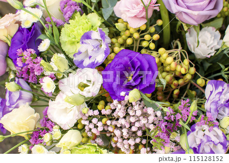a bouquet of various flowers of different colors close-up 115128152