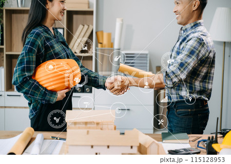 Engineer desk with object paper and tablet with blurry engineer teamwork hardworking to consults about their building 115128953
