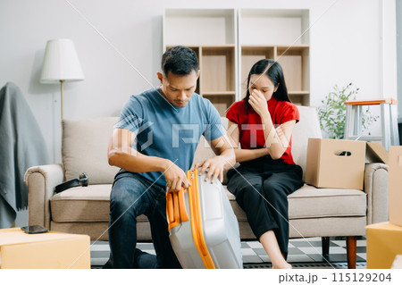Divorce. Asian couples are desperate and disappointed after marriage. Husband and wife are sad, upset and frustrated after quarrels. family problem, teenage love. on sofa 115129204