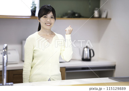 キッチンでくつろぐ笑顔の女性 115129889