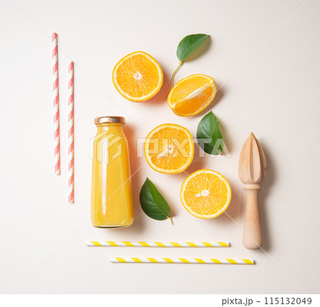 concept flat lay with fresh orange juice and fruits with green leaf on yellow  background. Top view 115132049