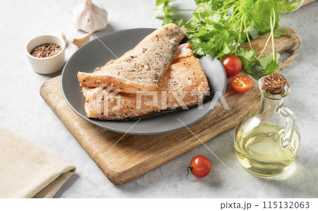Raw salmon, greased with marinade with spices on a plate on a light background Raw salmon, greased with marinade with spices on a plate on a light background 115132063