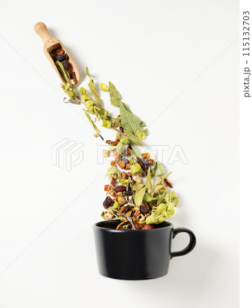 Black cup of herbal  tea with fruits on a white background. The concept of a healthy drink.  115132703