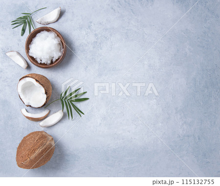 Eco friendly flat lay. Fresh coconut oil and coconut slices  on blue  background. Eco friendly flat lay. Fresh coconut oil and coconut slices  on blue  background. 115132755