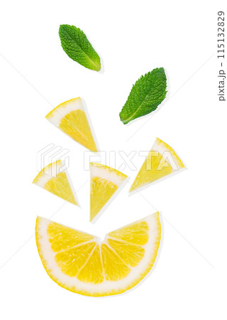 Flat lay of juicy slices of lemons and mint leaves on a light isolated background. 115132829