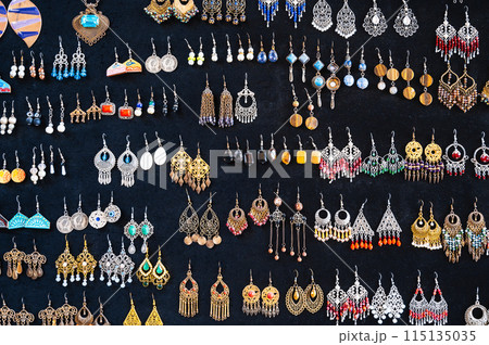 traditional oriental Uzbek earrings in Indian Asian ethnic style on a black background 115135035
