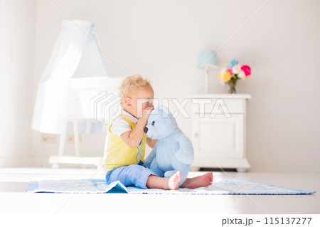 Little boy playing with toy teddy bear. Kids play. Little boy playing with toy teddy bear. Kids play. 115137277