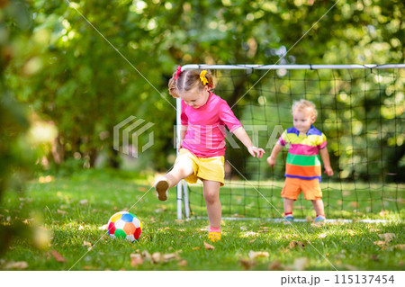 Kids play football. Child at soccer field. Kids play football. Child at soccer field. 115137454