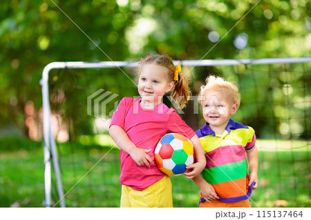Kids play football. Child at soccer field. 115137464